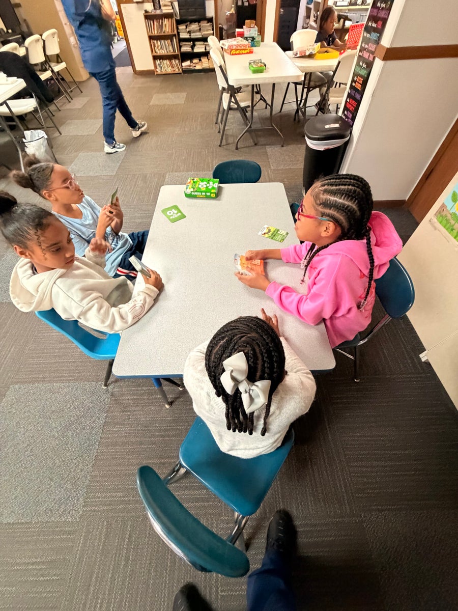 School-age children gathered around a classroom table at Beanstalk
